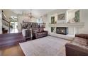 Inviting living room features a fireplace, hardwood floors, and seamless access to the dining area at 8224 Fawn Meadow Ave, Las Vegas, NV 89149