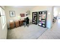 This home office has carpeting and a nice desk with lots of natural light coming from a window at 8305 Minots Ledge Ave, Las Vegas, NV 89147