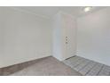 Clean entryway featuring carpeted floors, white trim, and a white front door at 8600 W Charleston Blvd # 1128, Las Vegas, NV 89117