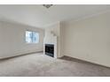 Bright living room features neutral carpet, crown molding, and a decorative fireplace at 8600 W Charleston Blvd # 1128, Las Vegas, NV 89117