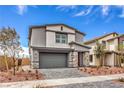 Charming two-story home featuring a brick driveway, gray stucco, stone accents, and a red front door at 1007 Gentle Swan St # Lot 699, Henderson, NV 89011