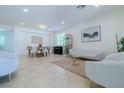 Open-concept living and dining area featuring neutral decor and elegant furnishings at 10744 Balsam Creek Ave, Las Vegas, NV 89144