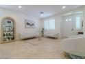 Bright living room with tile floors, modern sofas, and custom built-in display cabinet at 10744 Balsam Creek Ave, Las Vegas, NV 89144