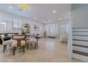 Spacious living area flows into the dining space, offering great natural light and stylish decor at 10744 Balsam Creek Ave, Las Vegas, NV 89144
