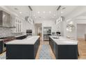 Spacious, contemporary kitchen featuring dual islands, stainless steel appliances, and modern lighting at 11 Misty Peaks Ct, Las Vegas, NV 89135