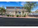 Charming townhome featuring a well-kept lawn, decorative accents, and a welcoming facade at 1101 Elation Ln # 2, Henderson, NV 89002