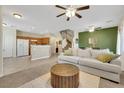Open-concept living space with staircase, neutral sofa, and seamless flow to the kitchen at 1101 Elation Ln # 2, Henderson, NV 89002
