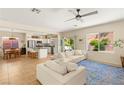 Spacious open-concept living area with tile floors and seamless connection to the kitchen and dining space at 11226 Kenyan Sunshine Ct, Las Vegas, NV 89138