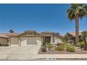 Charming single-story home featuring desert landscaping, a two-car garage, and a classic tile roof at 1128 Galangate Ave, Henderson, NV 89015