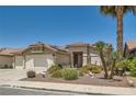 Well-maintained one-story home boasts desert landscaping, a two-car garage, and a red tile roof at 1128 Galangate Ave, Henderson, NV 89015