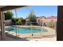 Inviting backyard pool enclosed with a -safety fence, perfect for relaxation and recreation at 1128 Galangate Ave, Henderson, NV 89015