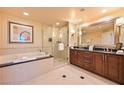 Modern bathroom with large tub, walk-in shower, and double sink vanity at 145 E Harmon Ave # 919, Las Vegas, NV 89109