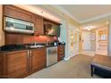 A convenient kitchenette features wooden cabinets and stainless steel appliances at 145 E Harmon Ave # 919, Las Vegas, NV 89109