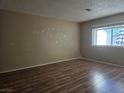 Cozy bedroom with wood floors and a bright window showcasing lots of natural light at 2116 Bavington Dr # C, Las Vegas, NV 89108