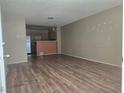 Inviting living room features open layout, wood flooring, and views into kitchen area at 2116 Bavington Dr # C, Las Vegas, NV 89108