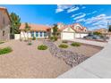 Charming single-story home with a two-car garage, tile roof, and desert landscaping at 234 Geronimo Ct, Henderson, NV 89074