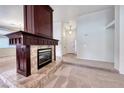 Spacious living room featuring plush carpeting and a charming fireplace focal point at 234 Geronimo Ct, Henderson, NV 89074