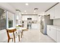 Modern eat-in kitchen with white cabinetry, stainless steel appliances, and quartz countertops at 2429 Worchester Rd, Henderson, NV 89074