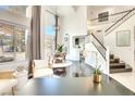 Bright and airy living room with high ceilings, large windows, and elegant staircase at 2429 Worchester Rd, Henderson, NV 89074