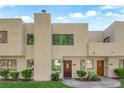 A view of the townhouse exterior featuring a well-manicured lawn and desert landscaping at 2661 Ruthe Duarte Ave, Las Vegas, NV 89121