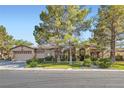 Attractive single-Gathering home with well-maintained landscaping, three-car garage, and inviting curb appeal at 313 Glenridding St, Las Vegas, NV 89183