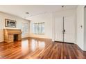 Spacious living room with hardwood floors, large windows, and modern lighting at 313 Glenridding St, Las Vegas, NV 89183