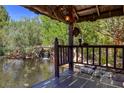 Private pond with waterfall feature viewed from a covered patio at 3330 Wedo Way, North Las Vegas, NV 89031