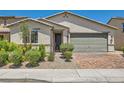 Beautiful desert home with a two-car garage, neutral color scheme, and low maintenance landscaping at 3716 W Colton Ave, North Las Vegas, NV 89032