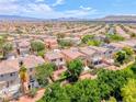 Scenic aerial view of a residential community with lush trees, mountain range backdrop at 4044 Villeroy Ave, Las Vegas, NV 89141