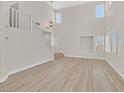 Spacious living room with high ceilings, large windows and neutral walls at 4132 Joyous St, North Las Vegas, NV 89032