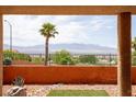 Scenic backyard showcasing xeriscaping and mountain views, framed by a covered patio, creating a serene outdoor space at 414 Crystal Canyon Dr, Mesquite, NV 89027