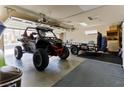 Spacious garage with an all-terrain vehicle and trailer at 414 Crystal Canyon Dr, Mesquite, NV 89027