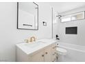 Modern bathroom with a white vanity, gold hardware, and a tiled shower with black fixtures at 4312 Chrysalis Dr, Las Vegas, NV 89121
