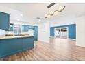 Open-concept kitchen featuring blue cabinetry, stainless steel appliances, and an island with granite countertops at 4312 Chrysalis Dr, Las Vegas, NV 89121