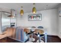 Contemporary kitchen island with seating, stainless steel appliances, dark wood floors, and modern lighting at 4381 W Flamingo Rd # 1121, Las Vegas, NV 89103