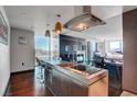 Modern kitchen featuring sleek stainless steel appliances, dark wood floors, and stunning city views at 4381 W Flamingo Rd # 1121, Las Vegas, NV 89103