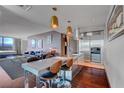 Stylish kitchen with stainless steel appliances, island with bar seating, and views of the living area and bedroom at 4381 W Flamingo Rd # 1121, Las Vegas, NV 89103