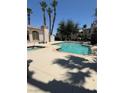 Inviting community pool area with mature palm trees, jacuzzi, and ample space for relaxation and recreation at 4555 E Sahara Ave # 122, Las Vegas, NV 89104