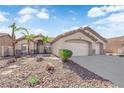 Attractive single-story home, xeriscaped front yard, and a two-car garage; perfect for desert living at 5437 Escallonia St, Las Vegas, NV 89149