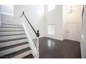Elegant staircase with dark wood treads, white risers, and a striking modern chandelier at 6029 Allanche Ave, Las Vegas, NV 89141