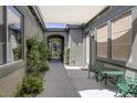 Charming covered patio with decorative metal table and chairs, offering a private outdoor space at 6173 Sabine Ranch Rd, Las Vegas, NV 89131