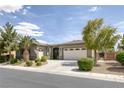 Beautiful single-story home with manicured landscaping, palm trees, and a driveway leading to an attached garage at 6173 Sabine Ranch Rd, Las Vegas, NV 89131