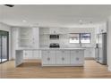 Bright, open kitchen with white cabinets, stainless steel appliances, and a large island with marble countertops at 6204 Robin Hood Cir, Las Vegas, NV 89108