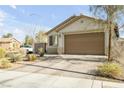 Well-maintained single-story home with desert landscaping, a spacious driveway, and a neutral color palette at 6318 Amber Sunrise St, North Las Vegas, NV 89031