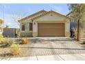 Beautiful single-story home featuring desert landscaping, a paved driveway, and a neutral color palette at 6318 Amber Sunrise St, North Las Vegas, NV 89031