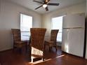 Cozy dining area features wood floors, wicker chairs, and natural light from the window at 634 Oakmont Ave # 1903, Las Vegas, NV 89109