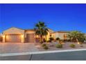 Charming single-story home featuring desert landscaping, a paver driveway, and a 3 car garage at 7504 Frittata Ave, Las Vegas, NV 89113