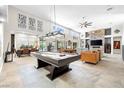 Spacious living area featuring ample natural light, a pool table, and an open floor plan at 7504 Frittata Ave, Las Vegas, NV 89113