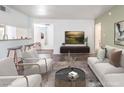 Open living room with modern furnishings, breakfast bar, and a view into another room at 753 Oakmont Ave # 802, Las Vegas, NV 89109