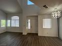 Open concept living room with wood-look floors, bright windows, and modern lighting at 8017 Cherish Ave, Las Vegas, NV 89128